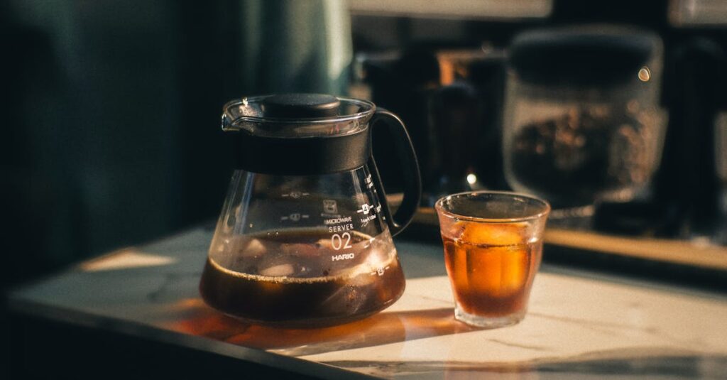 A serene still life of iced coffee in glass and carafe, bathed in warm sunlight on a marble countertop.